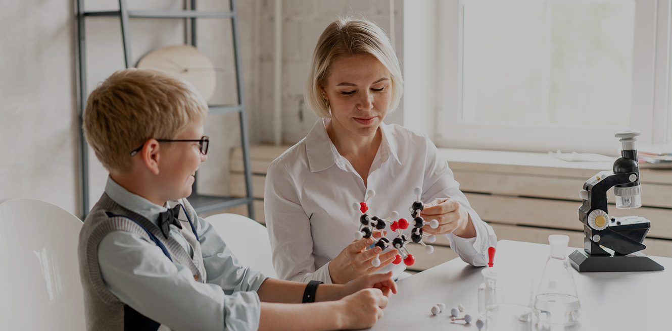 Female science tutor in Statten Island studying chemistry with student